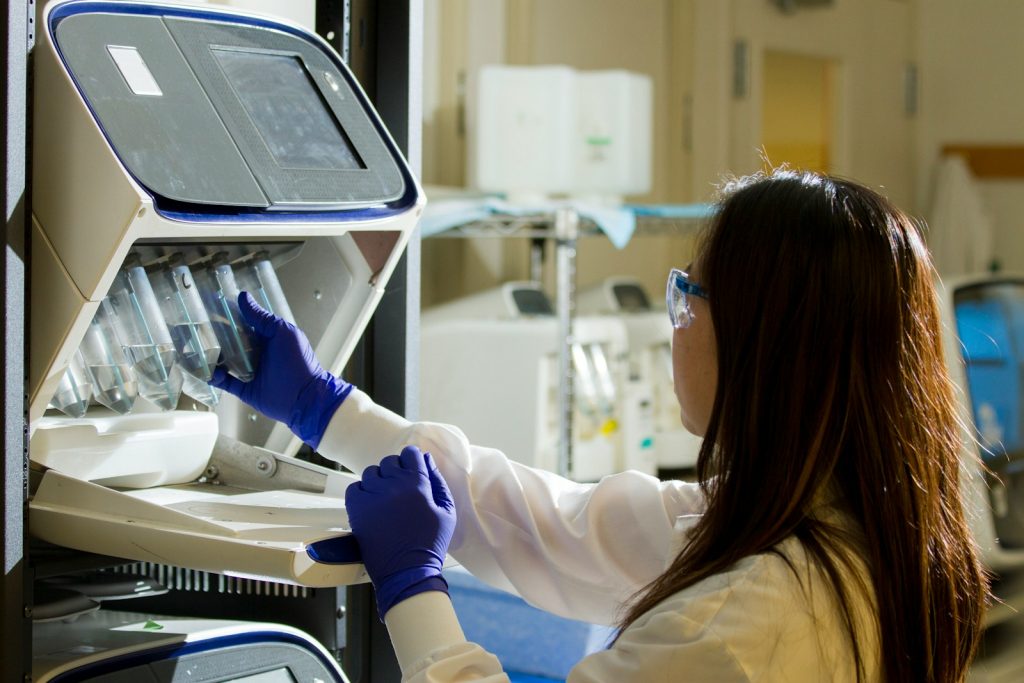 Bioinformatics & NGS Sequence Analysis with AI Internship – Student Applications Open Research technician working with genomic sequencing equipment in a laboratory, representing bioinformatics and NGS sequence analysis