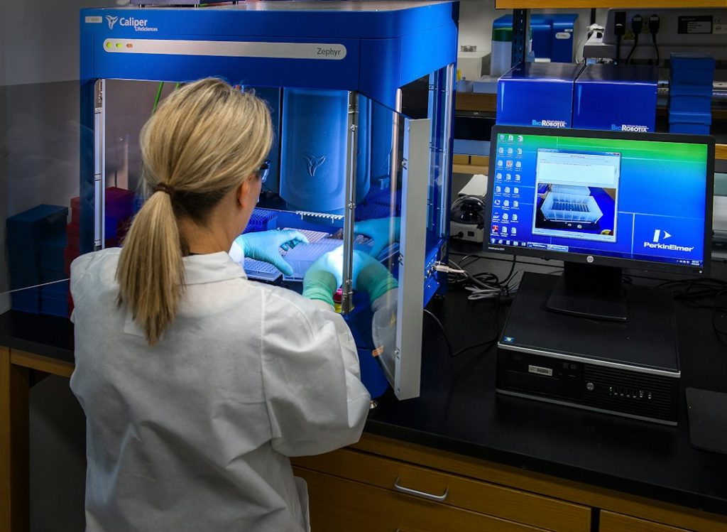 Bioinformatics for Beginners: Genomics, Python and Practical Projects Scientist working with molecular biology samples and analysis equipment