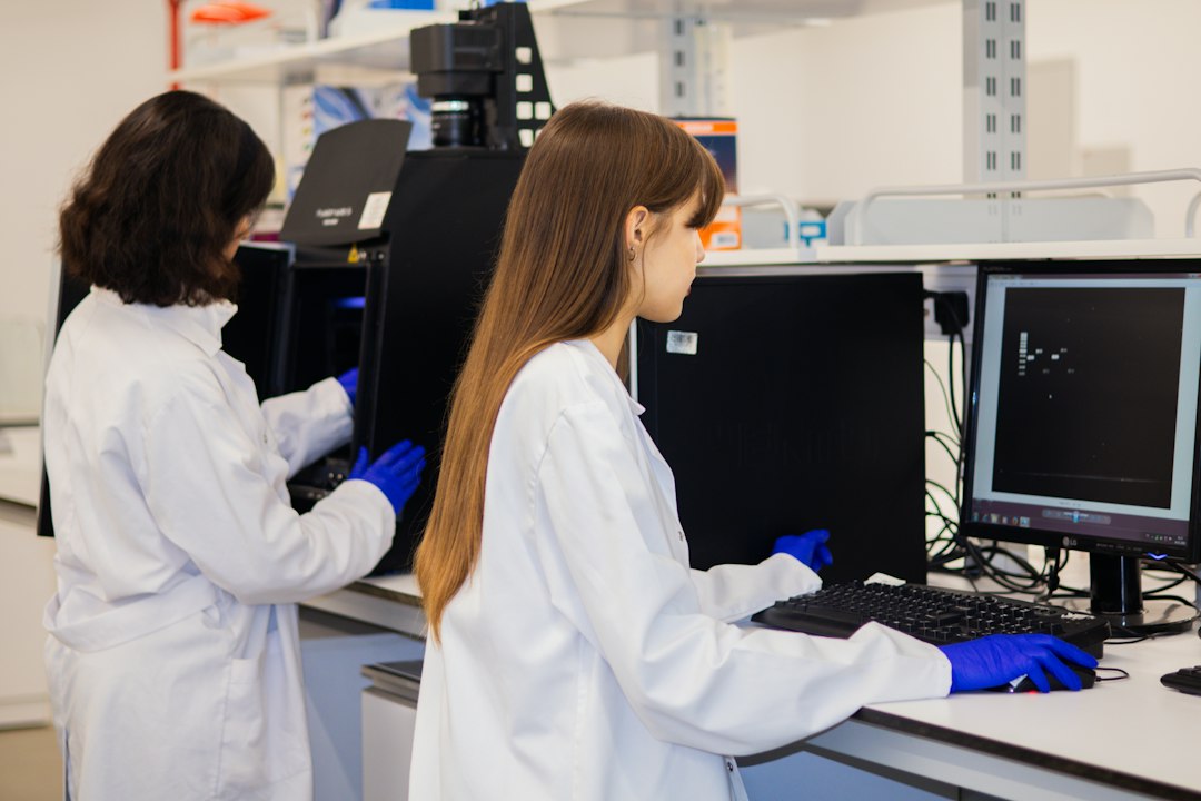 Scientists working together with data in a biotechnology research laboratory